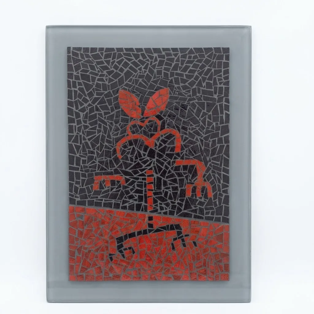 Mosaic of a red figure on black tile, set on a grey panel